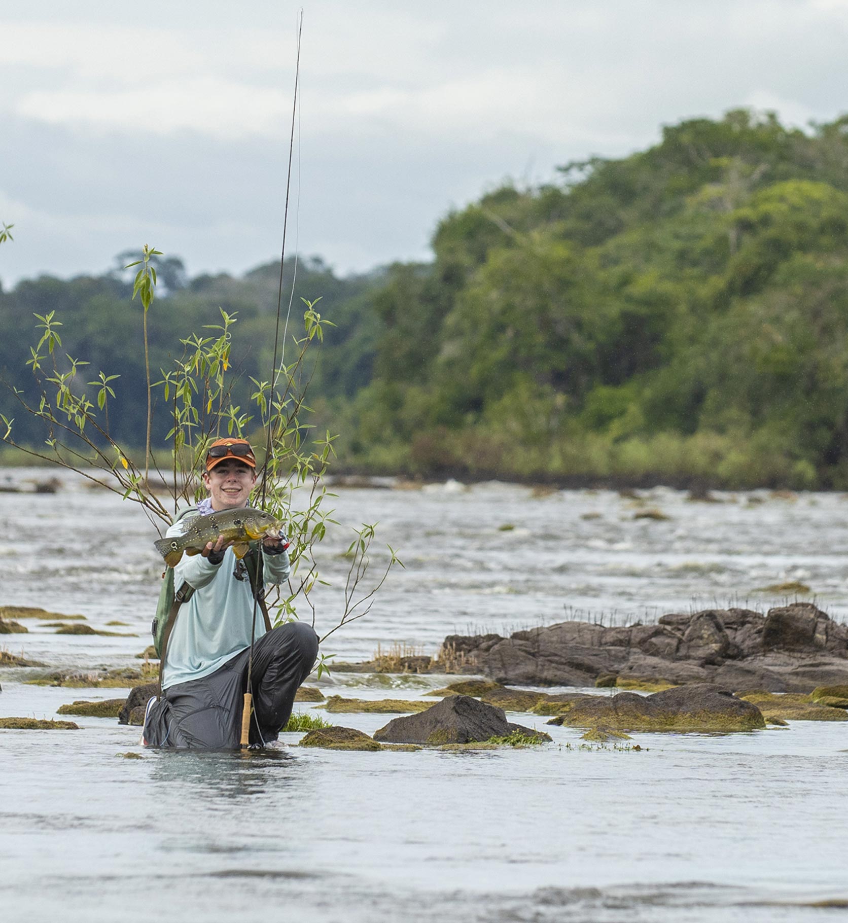 Fishing kid caught a fish on travel adventure