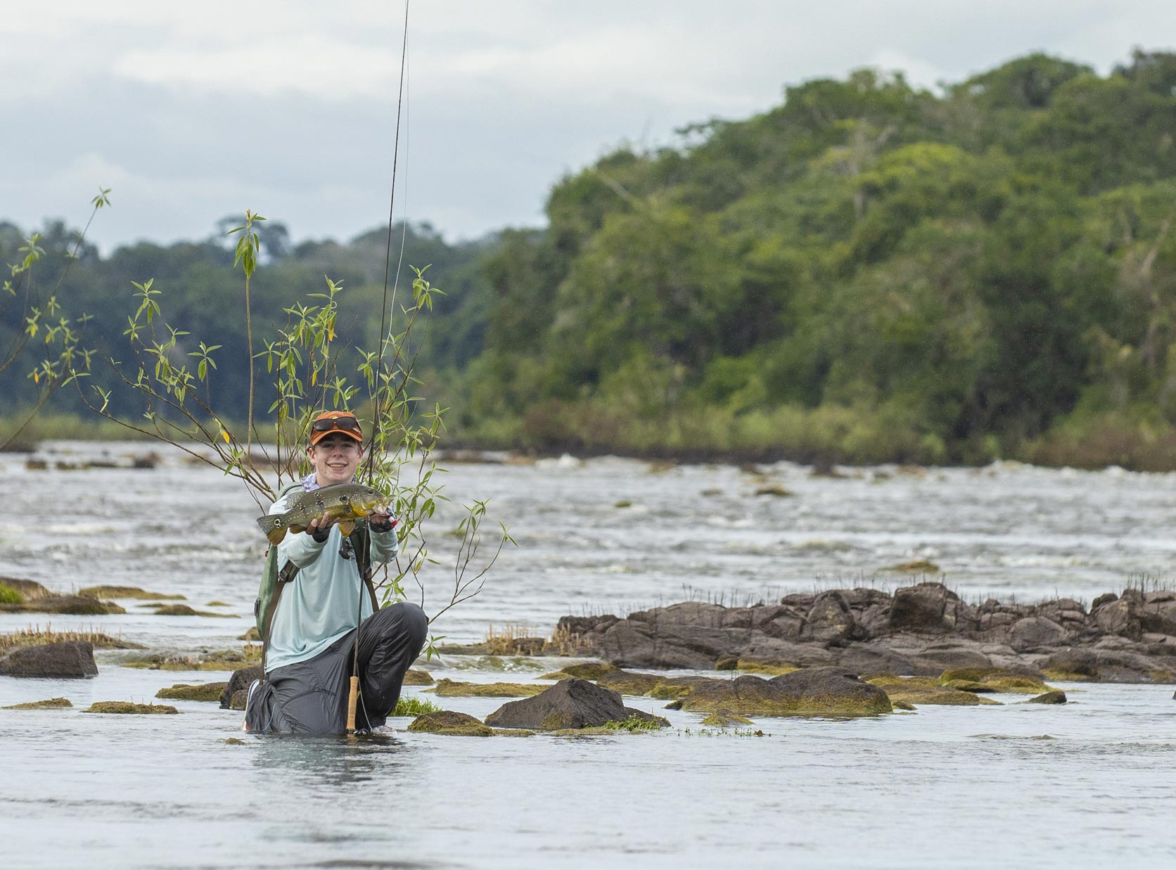 Fishing kid caught a fish on travel adventure